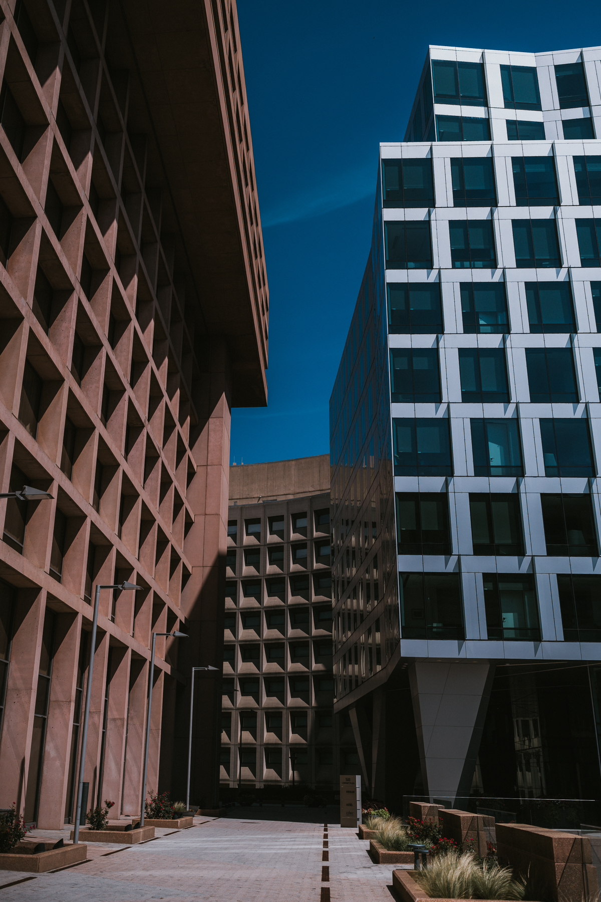 Geometric downtown Washington buildings against a deep blue sky