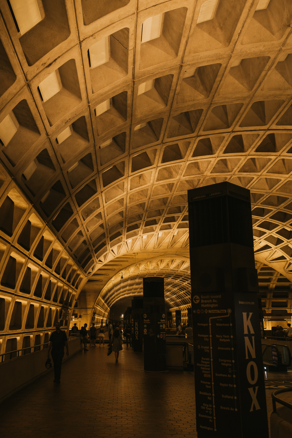 A tall view through the monumental concrete arches of the Washington Metro